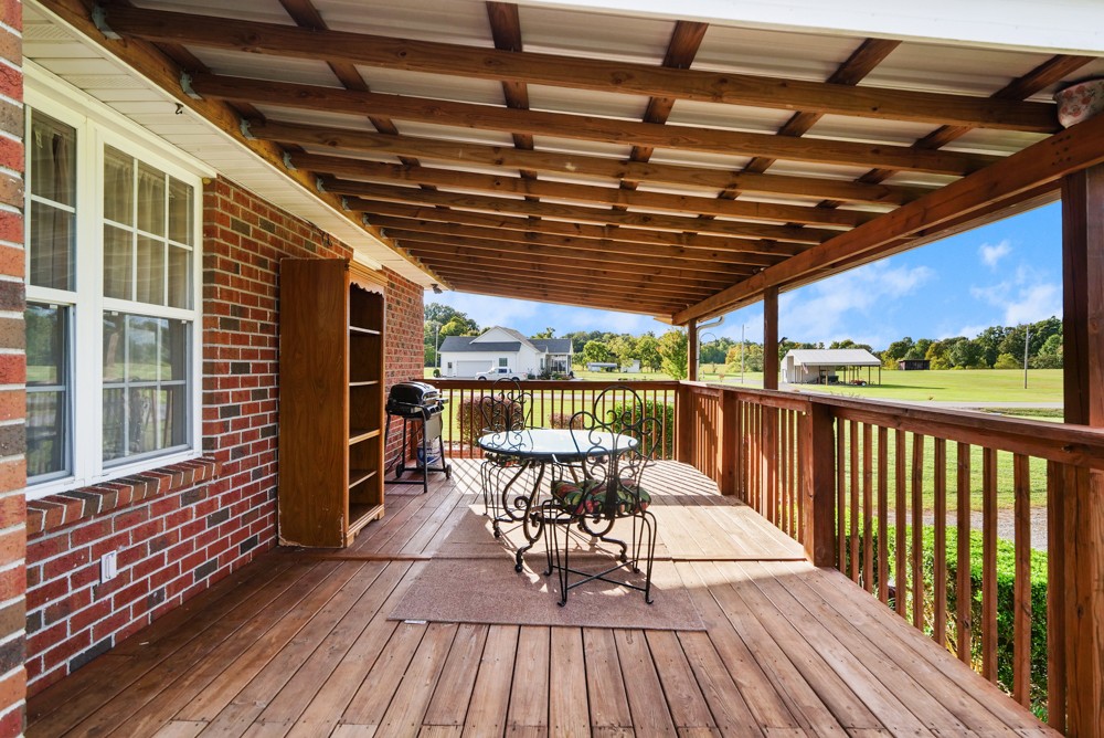 1303 Abiff Road Bon Aqua, TN 37025 - Photo 39 of 50 a view of a roof deck with dining table and wooden floor