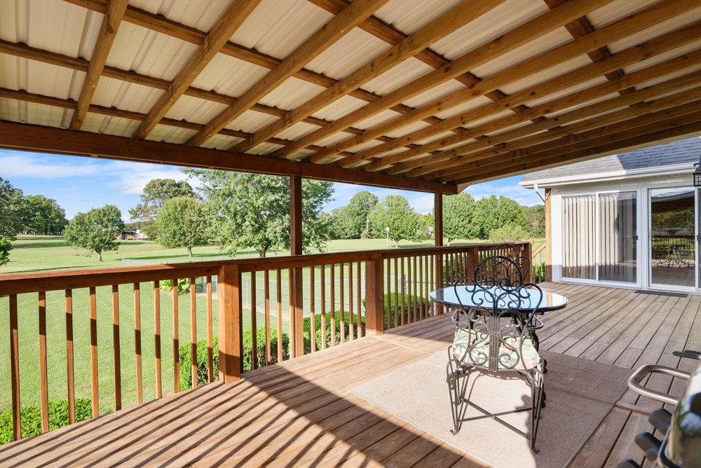 1303 Abiff Road Bon Aqua, TN 37025 - Photo 40 of 50 a view of a patio with a table chairs and wooden fence