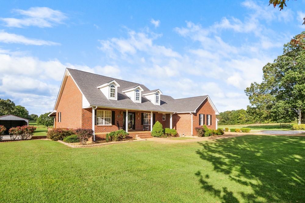1303 Abiff Road Bon Aqua, TN 37025 - Photo 4 of 50 a front view of a house with a yard table and chairs