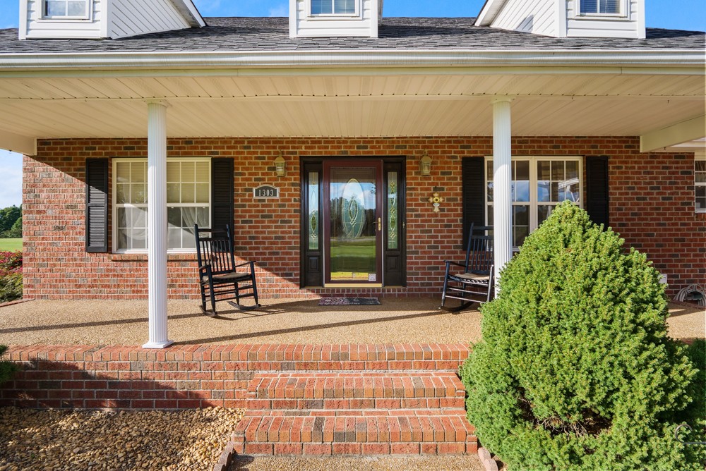 1303 Abiff Road Bon Aqua, TN 37025 - Photo 6 of 50 a front view of a house with a porch