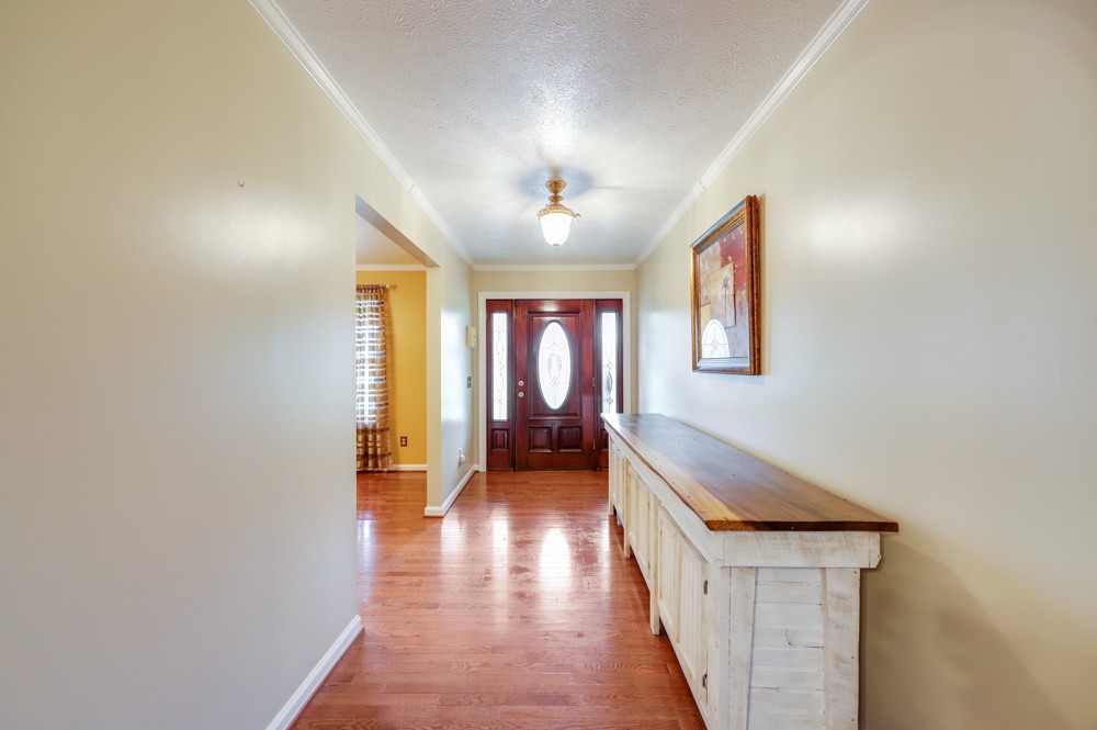 1303 Abiff Road Bon Aqua, TN 37025 - Photo 7 of 50 a hallway with a large window and a chandelier