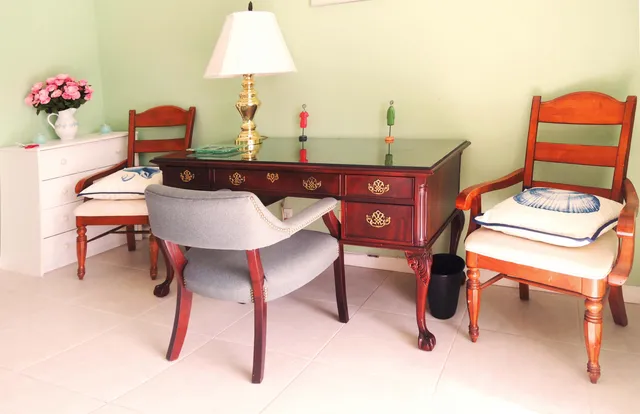 a dining room with furniture and a lamp