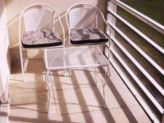 a bed with white sheets and pillows