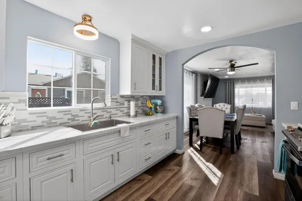 a large white kitchen with a large window