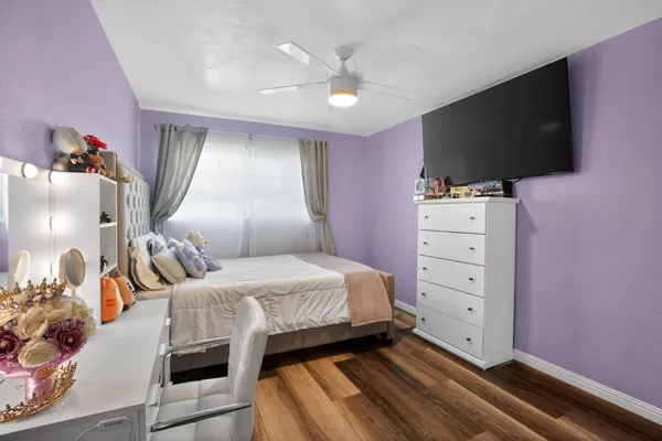 a bedroom with a bed and flat screen tv