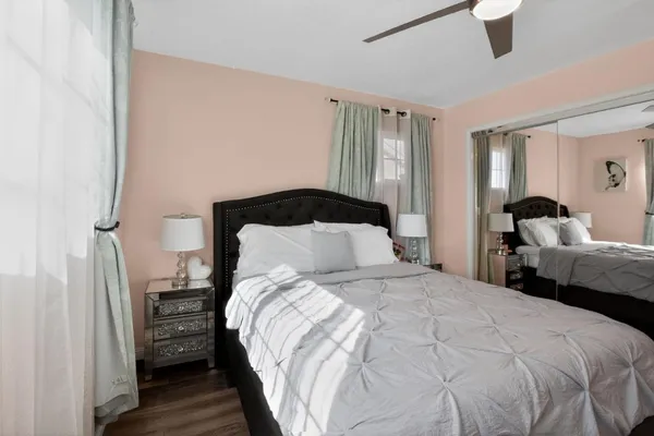 a bedroom with a bed and a large mirror