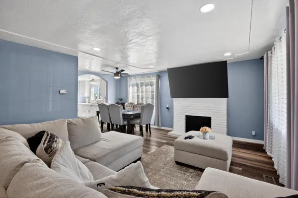 a living room with furniture a fireplace and a flat screen tv