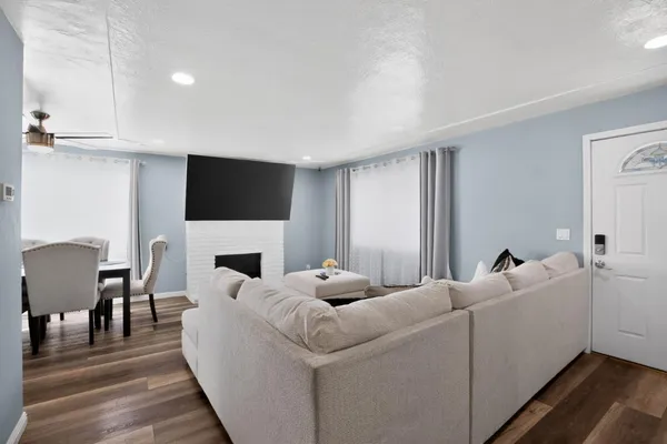 a living room with furniture a fireplace and a flat screen tv