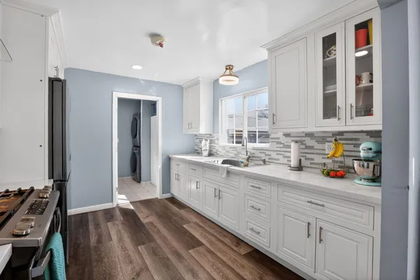 a kitchen with sink cabinets and refrigerator