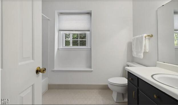3317 Harden Road Raleigh, NC 27607 - Photo 25 of 52 a bathroom with a granite countertop toilet a sink and a mirror
