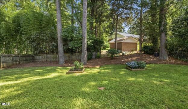 3317 Harden Road Raleigh, NC 27607 - Photo 44 of 52 a view of a backyard with table and chairs and potted plants and large trees