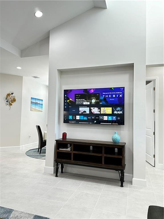 7135 Cayo Coco Lane Naples, FL 34113 - Photo 11 of 41 Living room featuring vaulted ceiling, light tile patterned floors, and recessed lighting