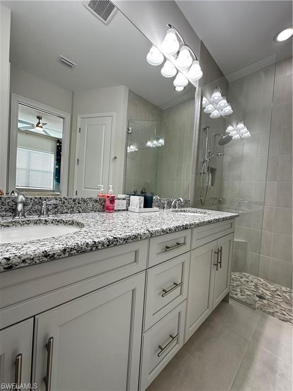7135 Cayo Coco Lane Naples, FL 34113 - Photo 14 of 41 Bathroom with double vanity, walk in shower, and a ceiling fan