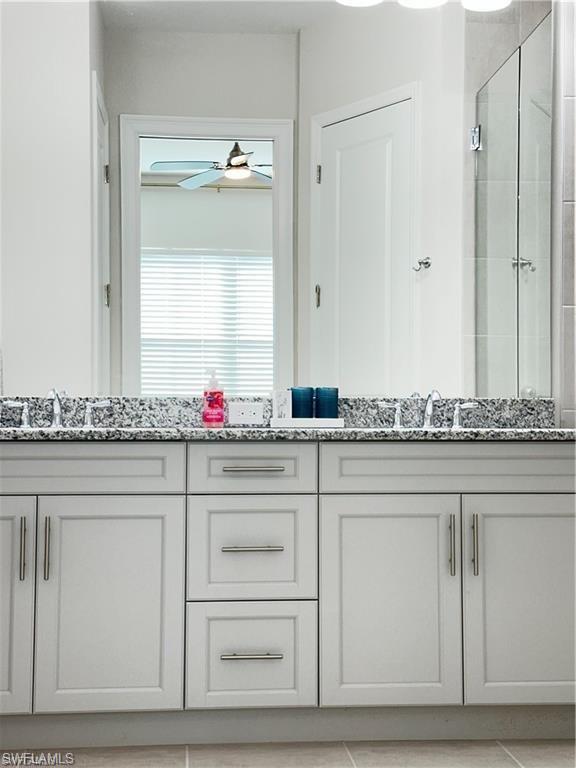 7135 Cayo Coco Lane Naples, FL 34113 - Photo 15 of 41 Bathroom with double vanity and a shower stall