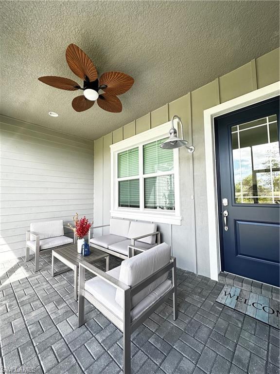 7135 Cayo Coco Lane Naples, FL 34113 - Photo 25 of 41 View of patio featuring an outdoor lounge area and ceiling fan