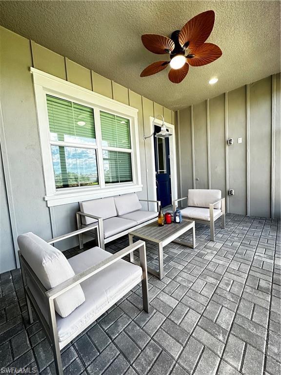 7135 Cayo Coco Lane Naples, FL 34113 - Photo 28 of 41 View of patio / terrace with an outdoor living space and a ceiling fan
