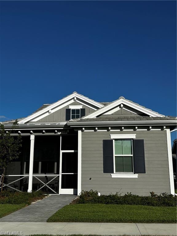 7135 Cayo Coco Lane Naples, FL 34113 - Photo 30 of 41 View of front of home with a sunroom