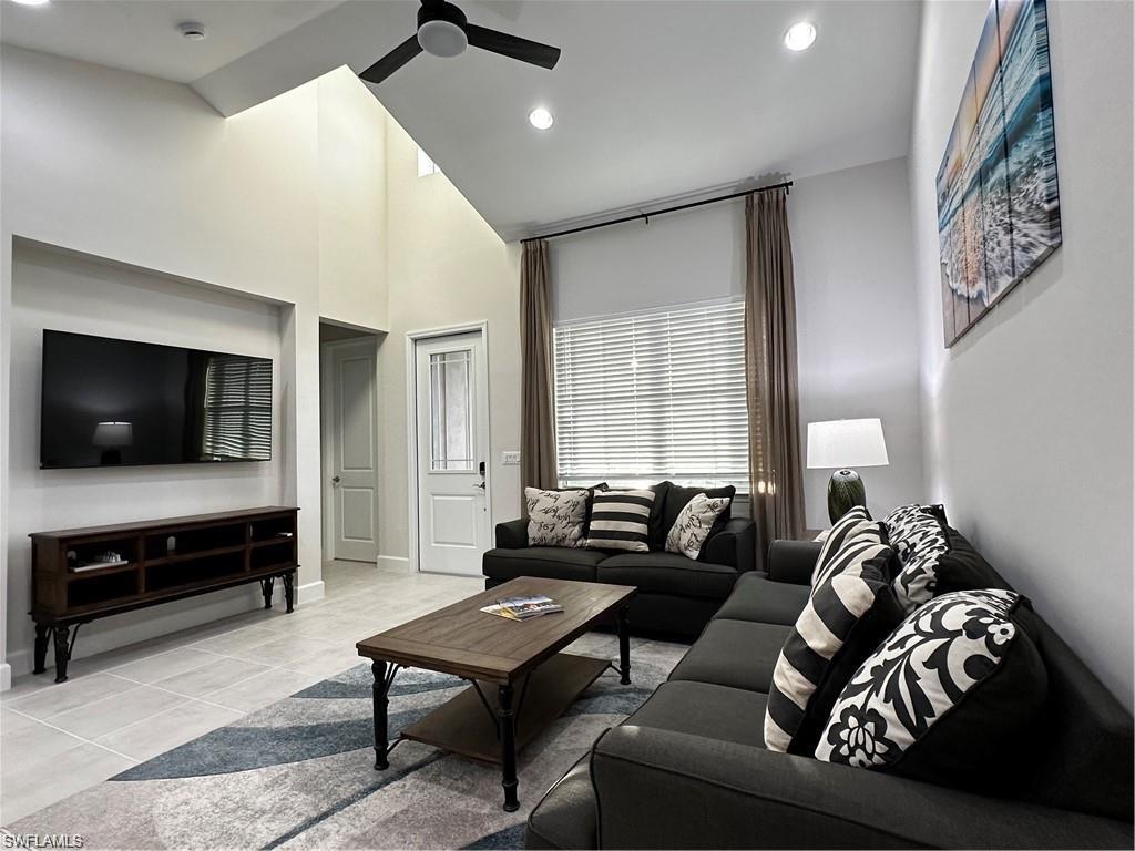 7135 Cayo Coco Lane Naples, FL 34113 - Photo 6 of 41 Living room with a ceiling fan, recessed lighting, light tile patterned floors, and vaulted ceiling