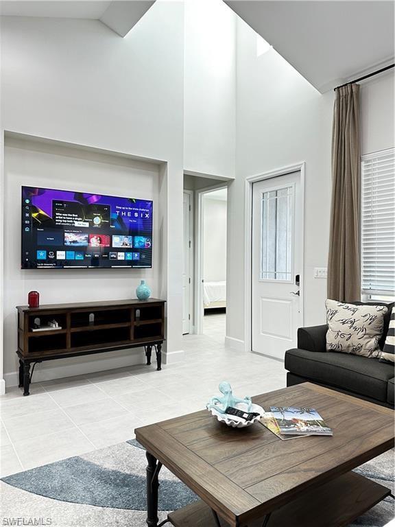 7135 Cayo Coco Lane Naples, FL 34113 - Photo 10 of 41 Living room featuring a high ceiling and baseboards