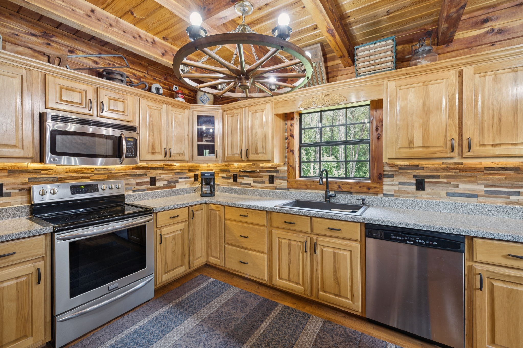 602 Gaither Hinson Road Waynesboro, TN 38485 - Photo 23 of 69 a kitchen with stainless steel appliances a stove a sink and a microwave