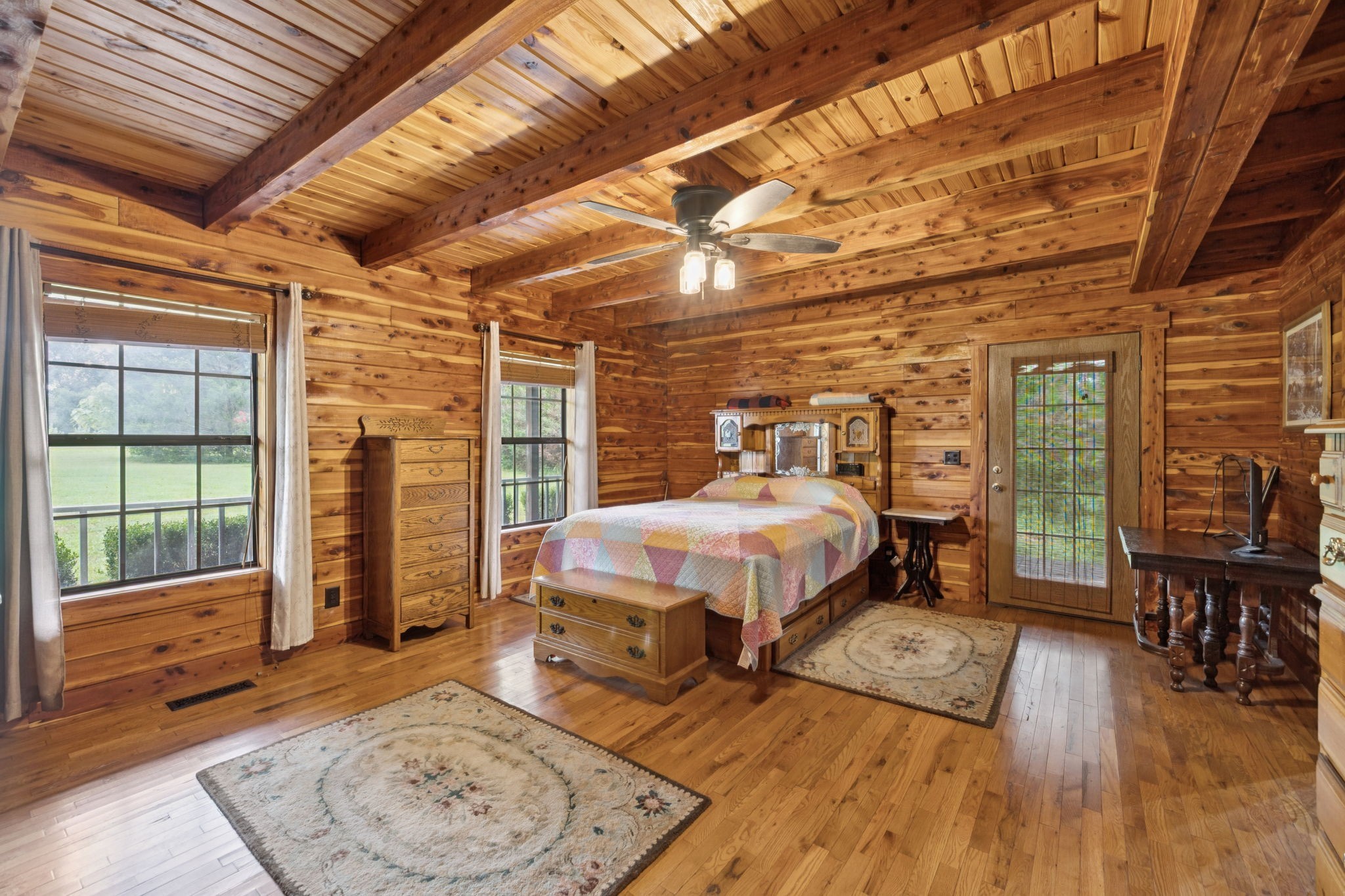 602 Gaither Hinson Road Waynesboro, TN 38485 - Photo 30 of 69 a spacious bedroom with a bed a table and wooden floor