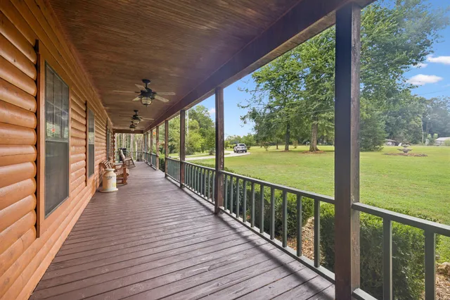 a view of a balcony with wooden floor