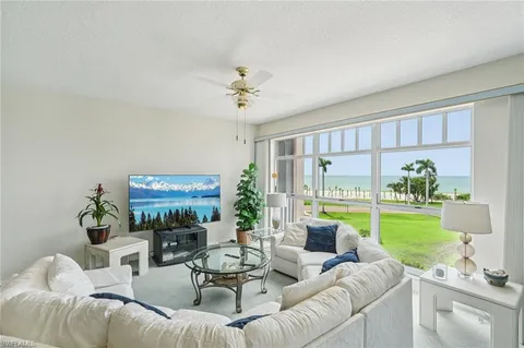 a living room with furniture and a large garden