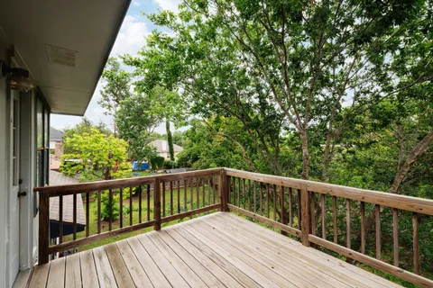 a view of a house with a backyard and a tree