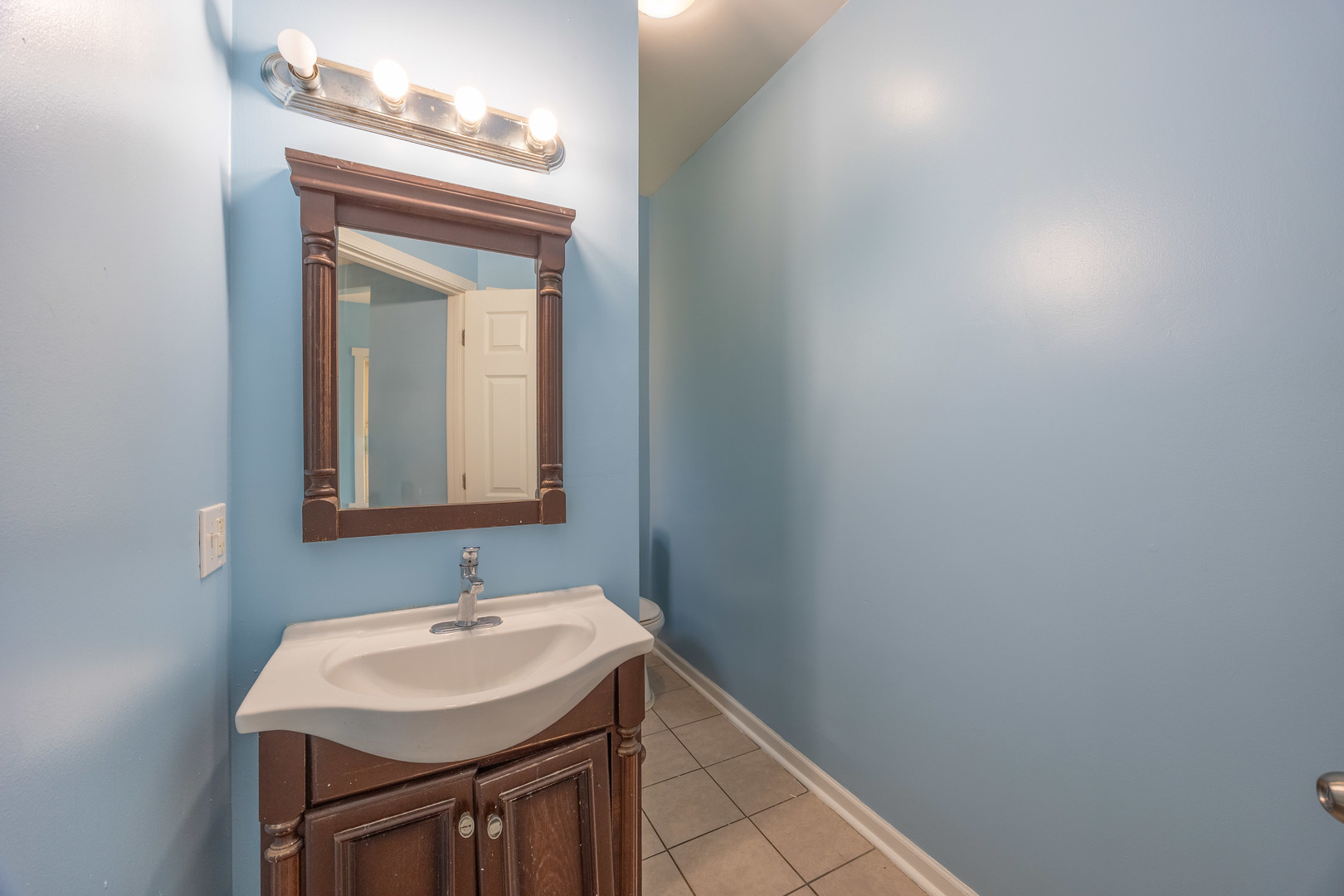 4058 West Congress Parkway, Unit 2S Chicago, IL 60624 - Photo 12 of 13 a bathroom with a sink and a mirror