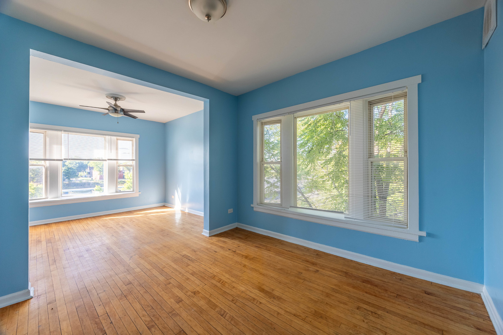 4058 West Congress Parkway, Unit 2S Chicago, IL 60624 - Photo 2 of 13 a view of an empty room with wooden floor and a window
