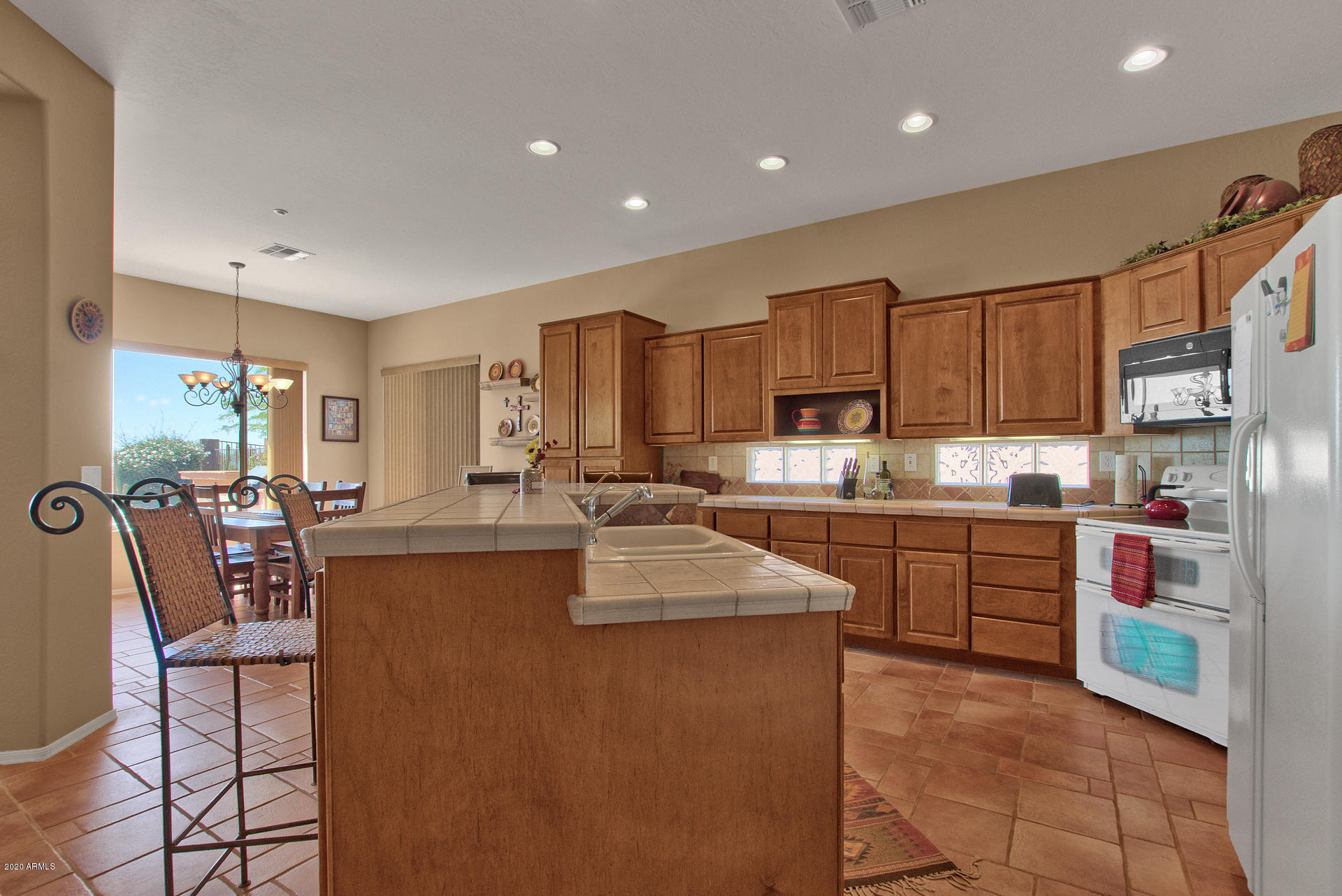 42045 North Crooked Stick Road Anthem, AZ 85086 - Photo 15 of 37 a kitchen with stainless steel appliances granite countertop a refrigerator sink and cabinets