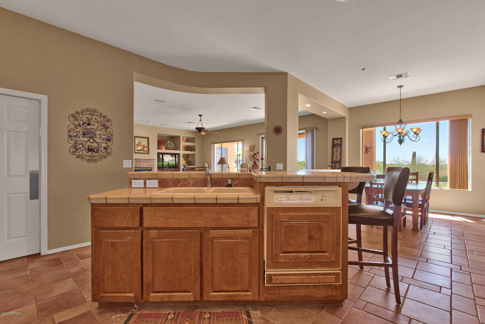 42045 North Crooked Stick Road Anthem, AZ 85086 - Photo 16 of 37 a kitchen with kitchen island granite countertop wooden cabinets and counter space
