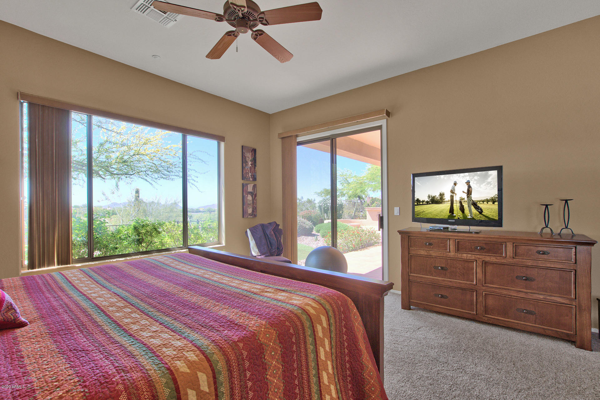 42045 North Crooked Stick Road Anthem, AZ 85086 - Photo 20 of 37 a bedroom with a large bed and a large window
