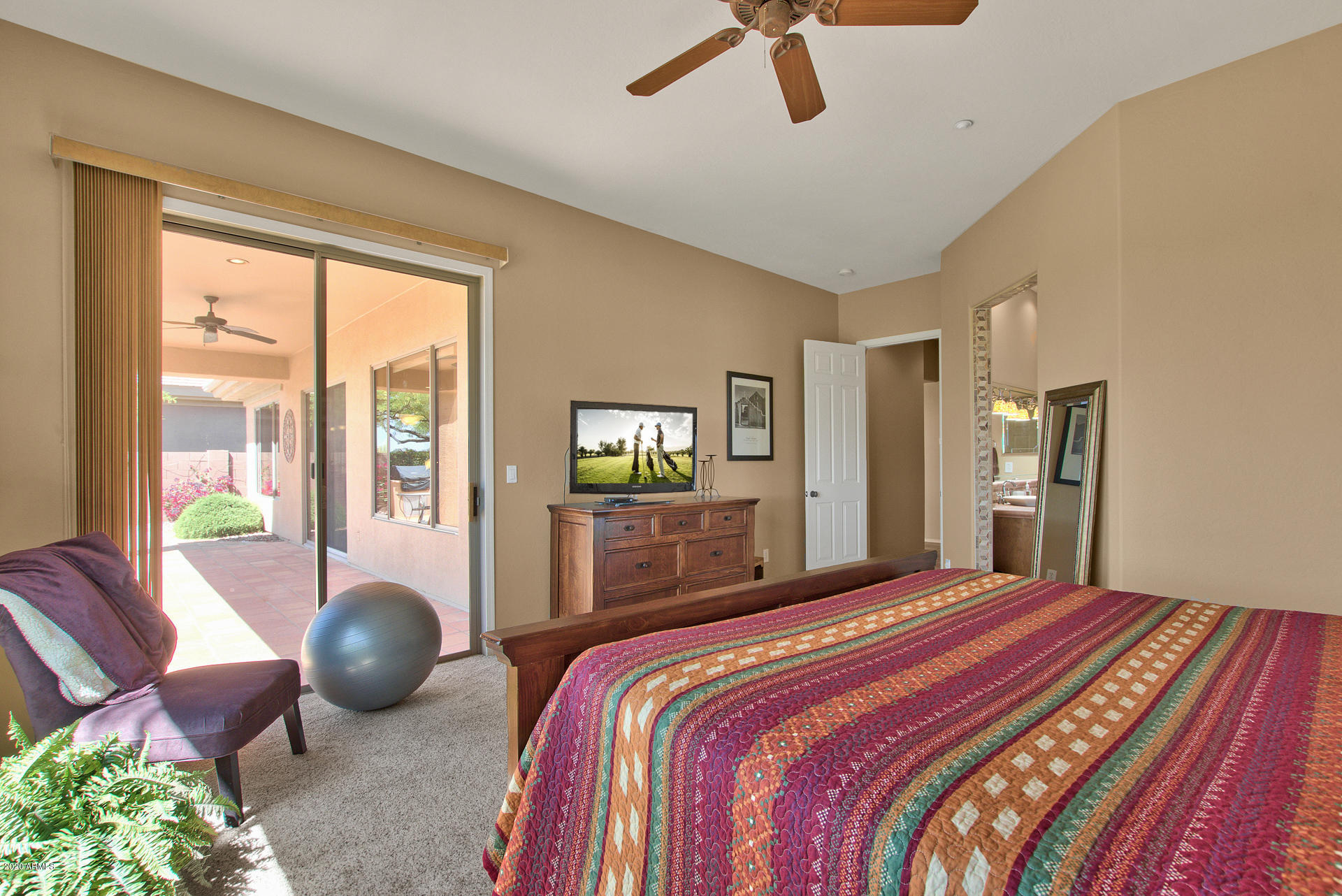 42045 North Crooked Stick Road Anthem, AZ 85086 - Photo 21 of 37 a bedroom with a bed and glass windows