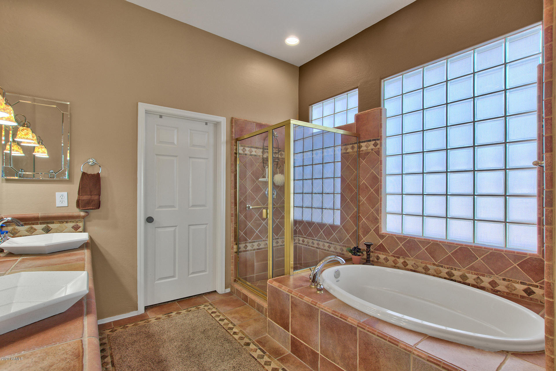42045 North Crooked Stick Road Anthem, AZ 85086 - Photo 22 of 37 a spacious bathroom with a tub and a sink