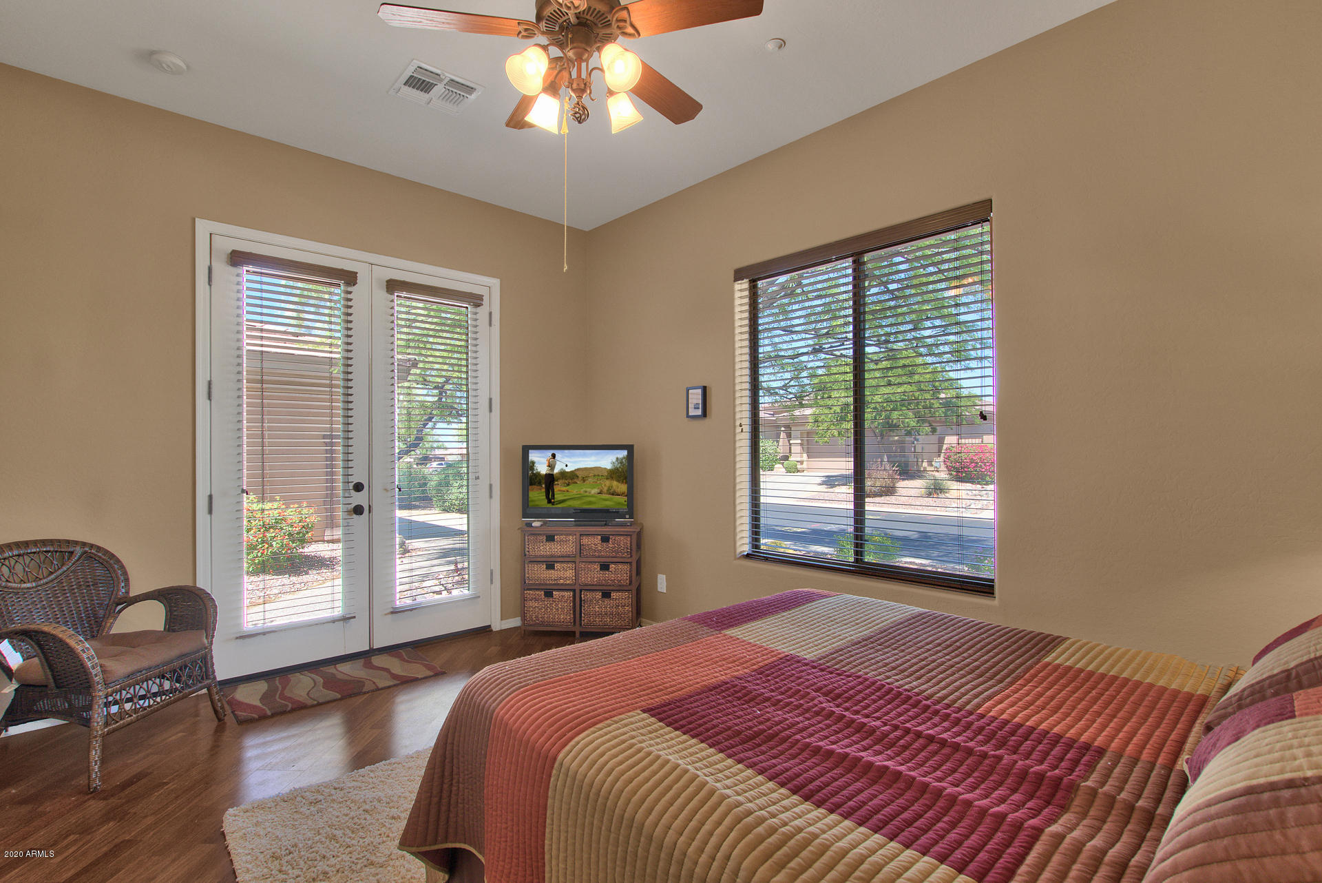42045 North Crooked Stick Road Anthem, AZ 85086 - Photo 27 of 37 a bedroom with a large bed and a tv