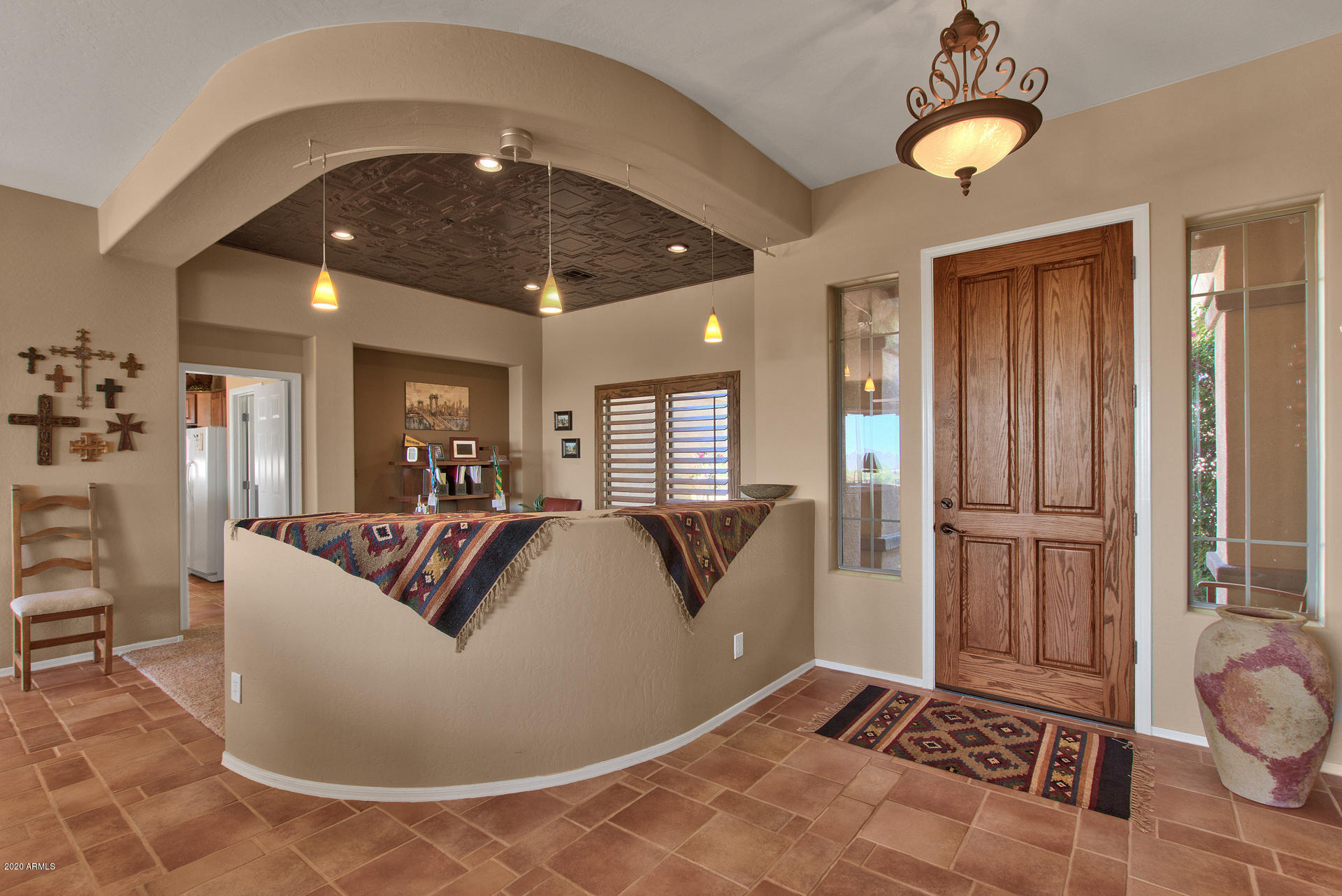 42045 North Crooked Stick Road Anthem, AZ 85086 - Photo 6 of 37 a living room with furniture and a chandelier