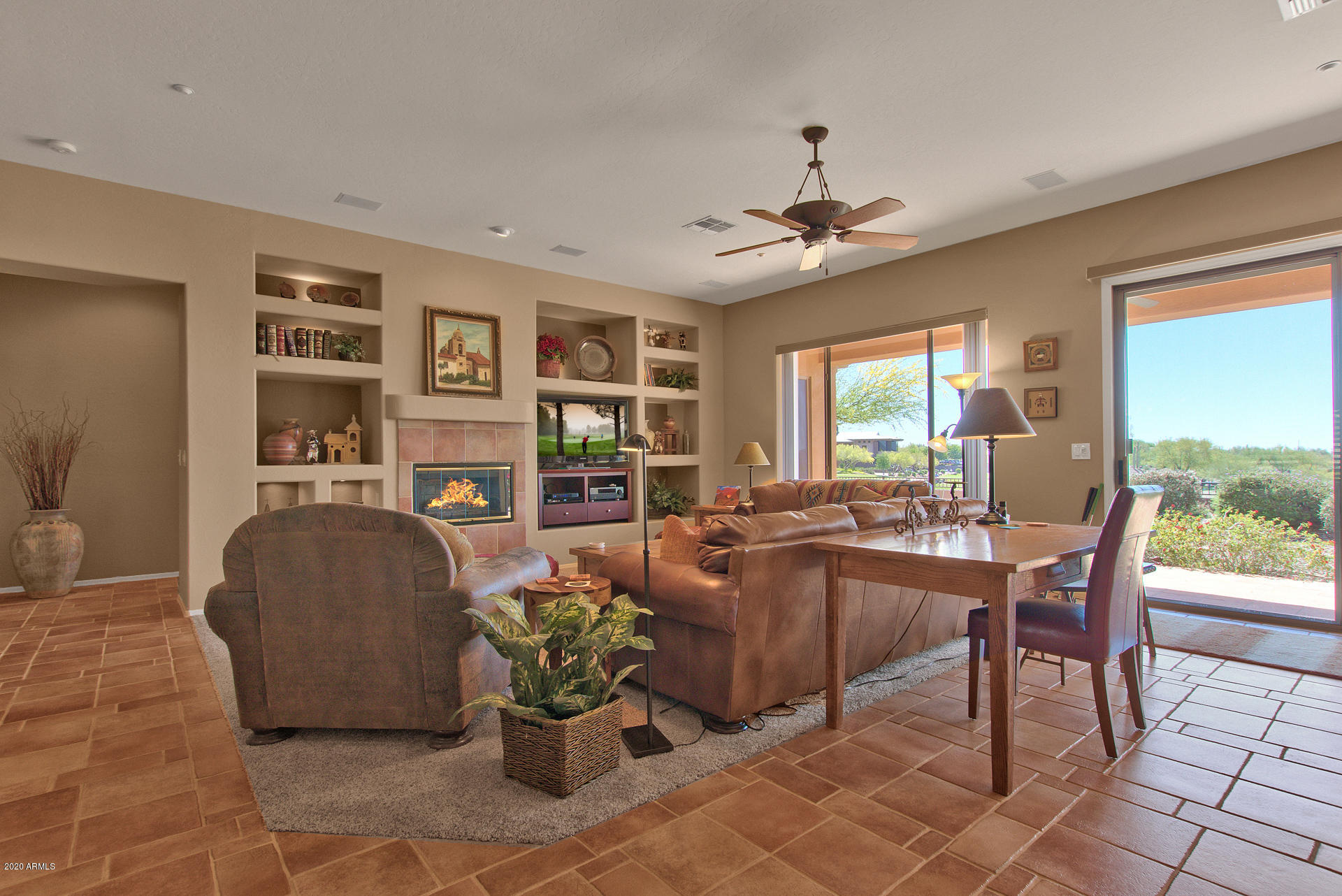 42045 North Crooked Stick Road Anthem, AZ 85086 - Photo 8 of 37 a living room with furniture a window and a chandelier