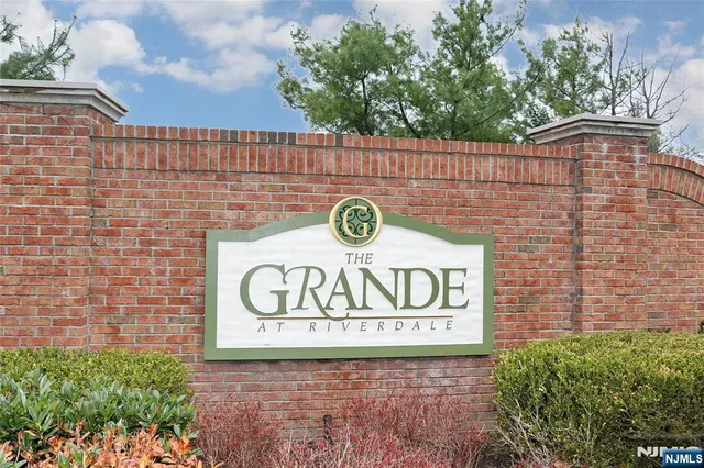 a sign that is on a brick wall