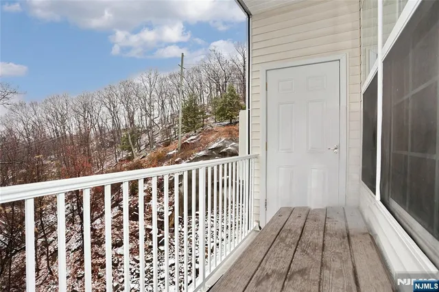 a view of a balcony with wooden floor