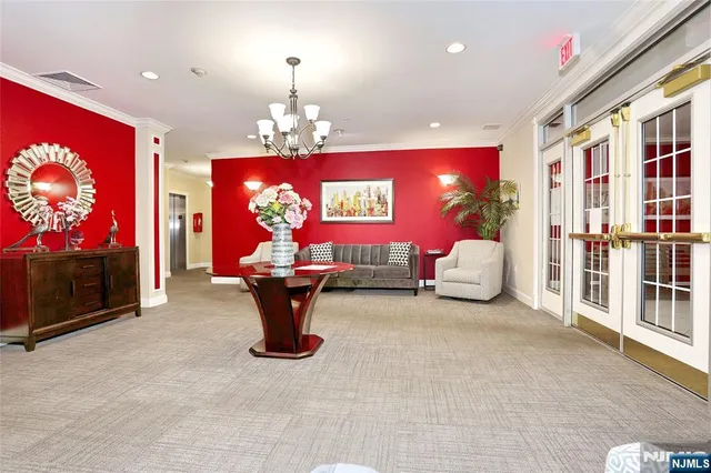 a living room with furniture a chandelier and a flat screen tv