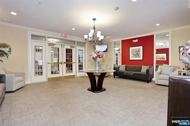 a living room with furniture a chandelier and a fireplace