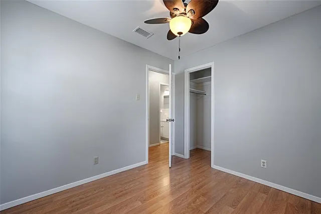 a view of an empty room and wooden floor