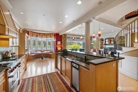 a kitchen with stainless steel appliances granite countertop a stove and a sink