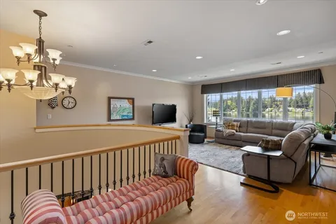 a living room with furniture fireplace and a large window