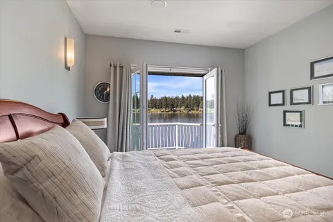 a bedroom with a bed and a large window