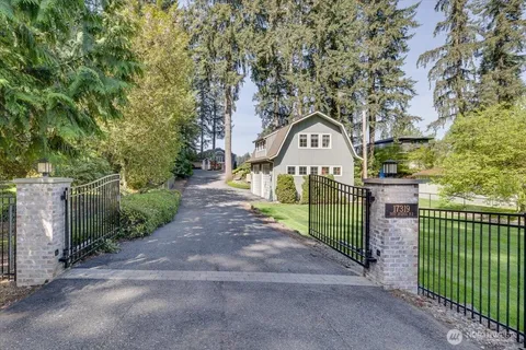 a view of a street in front of a house with a small yard