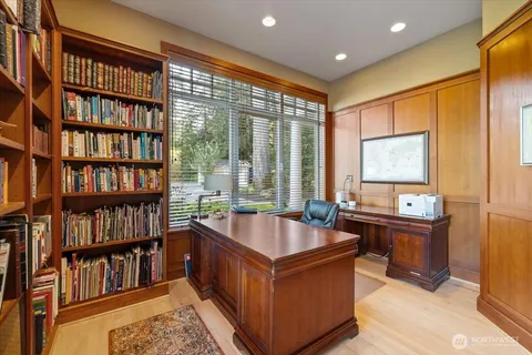 a living room with lots of furniture and a book shelf