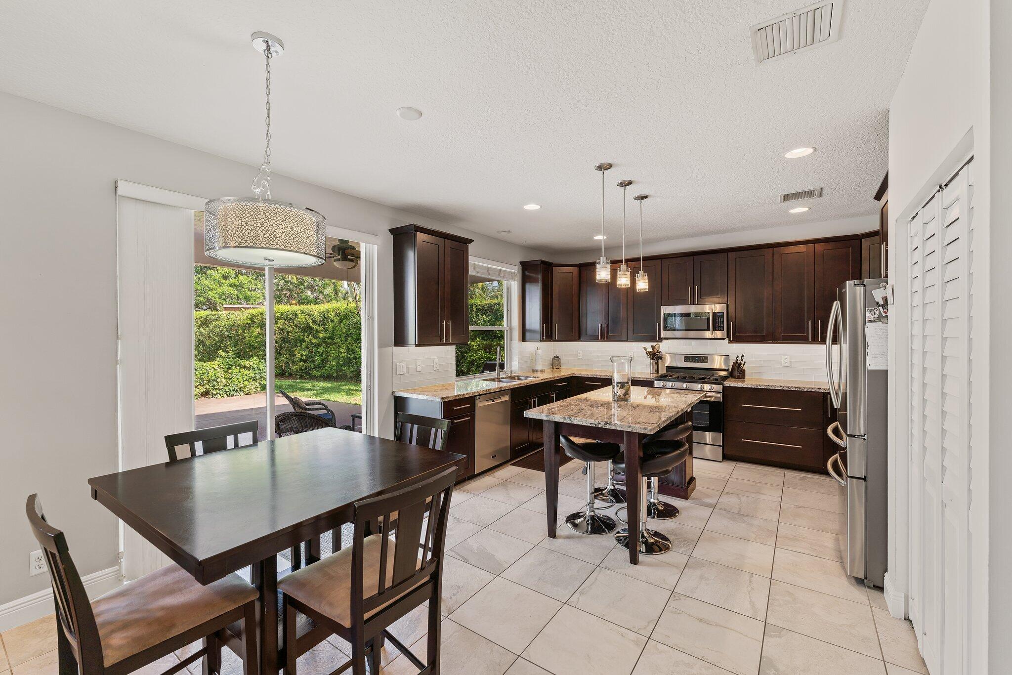 203 Anhinga Lane Jupiter, FL 33458 - Photo 11 of 63 a view of a dining room with furniture window and outside view