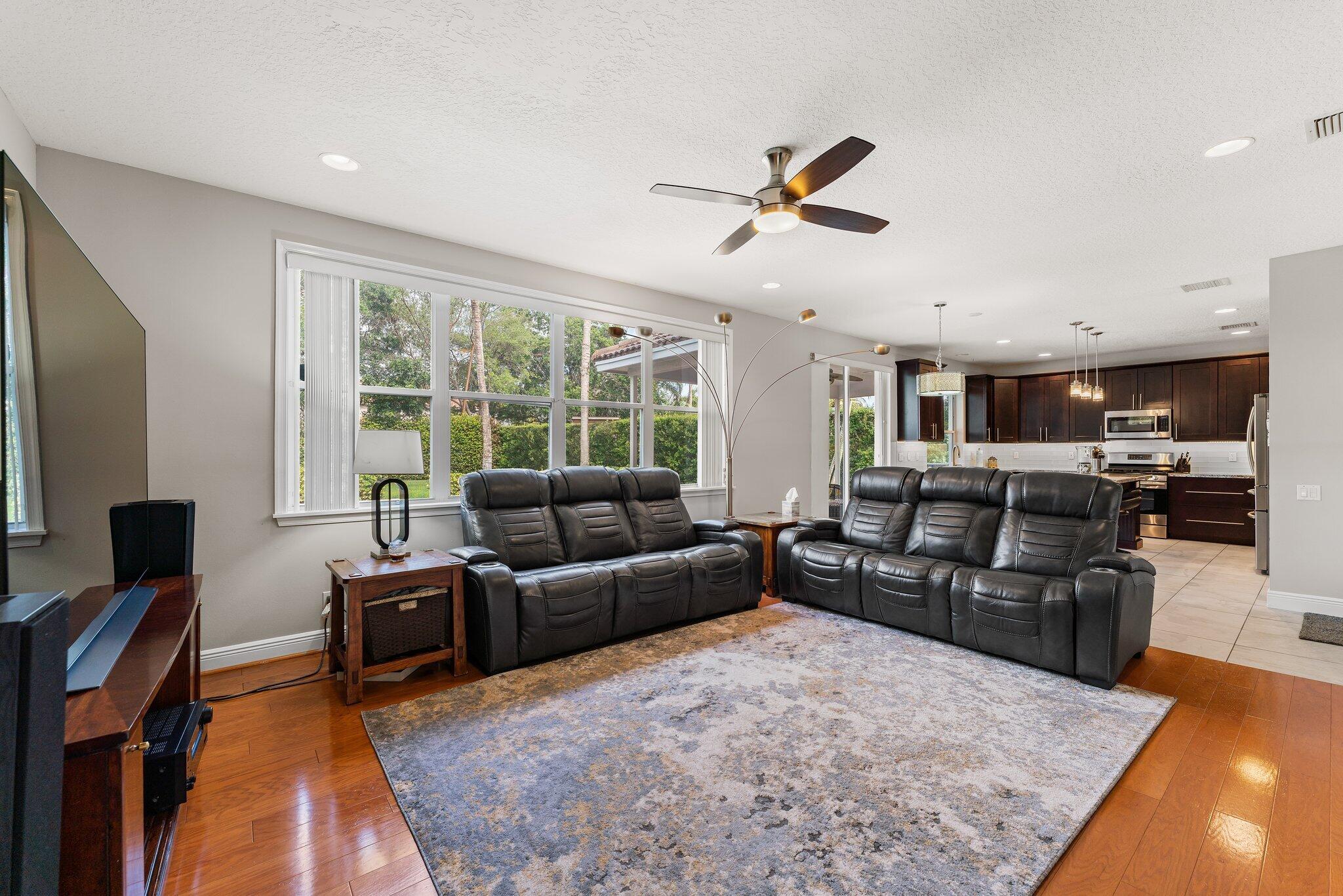 203 Anhinga Lane Jupiter, FL 33458 - Photo 14 of 63 a living room with furniture window and a flat screen tv